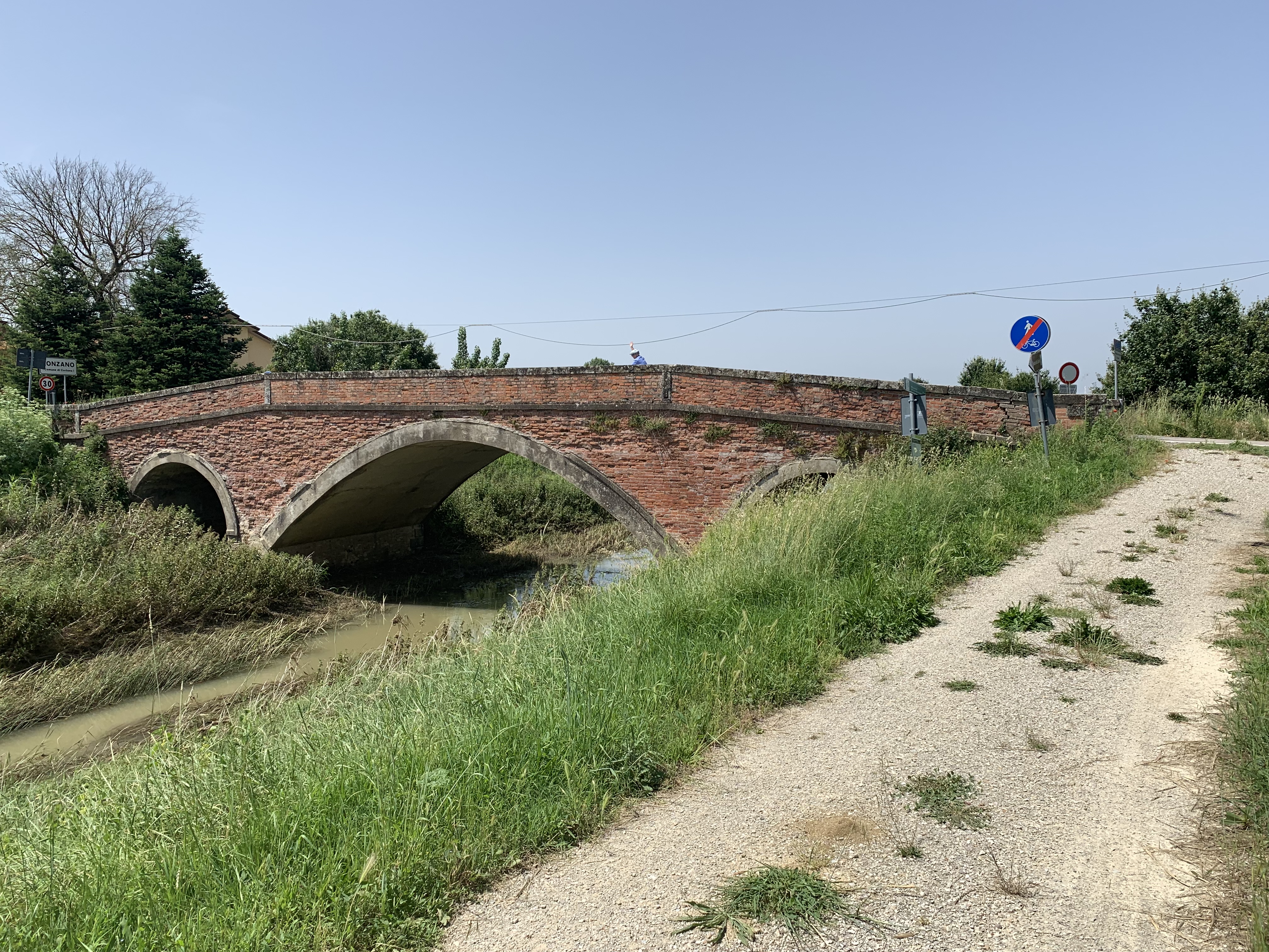 Old bridge along the Sentiero della Bonifica (note Mallory waving on bridge)