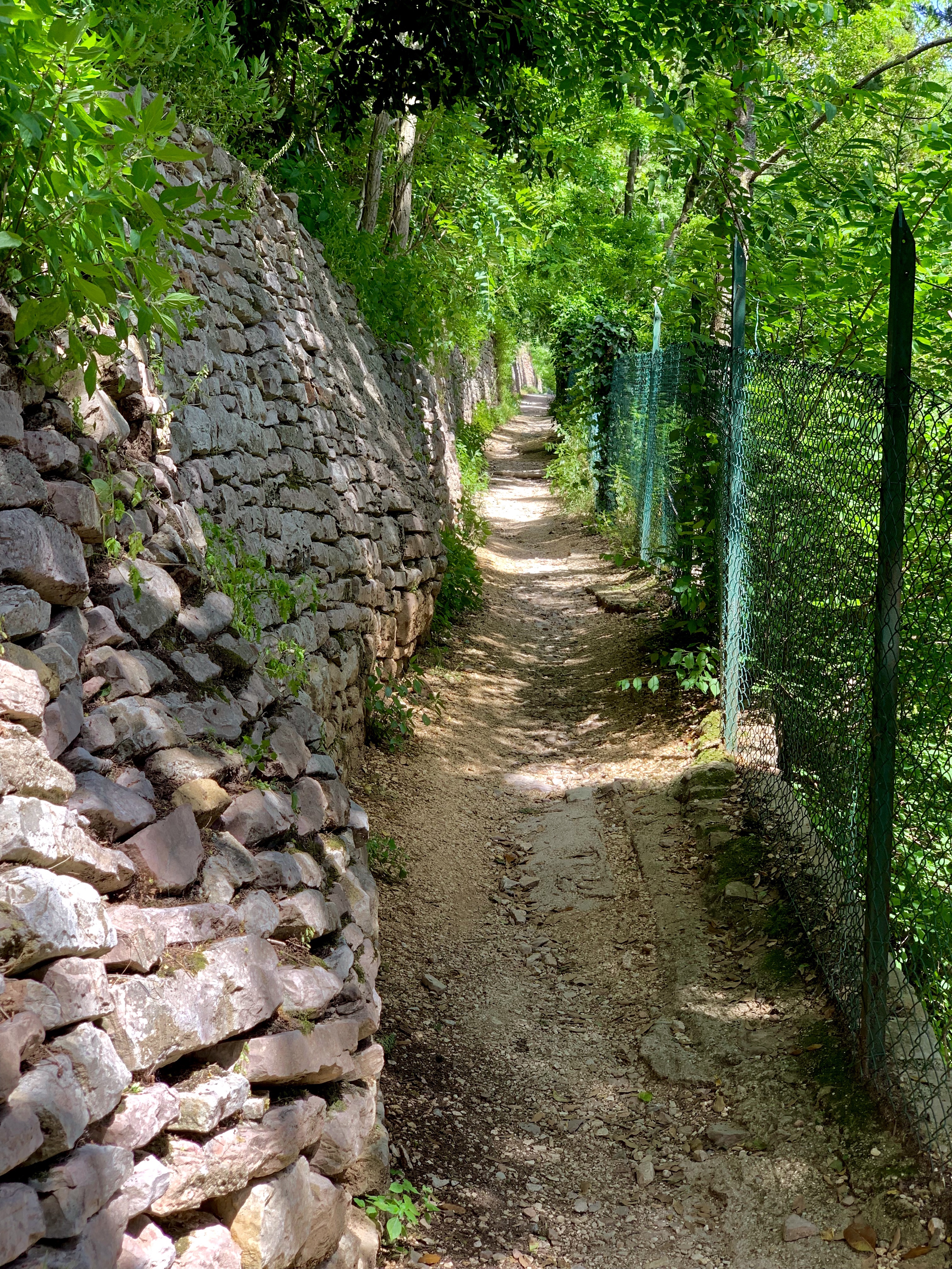 Gravel path, hard up against an ancient stone wall