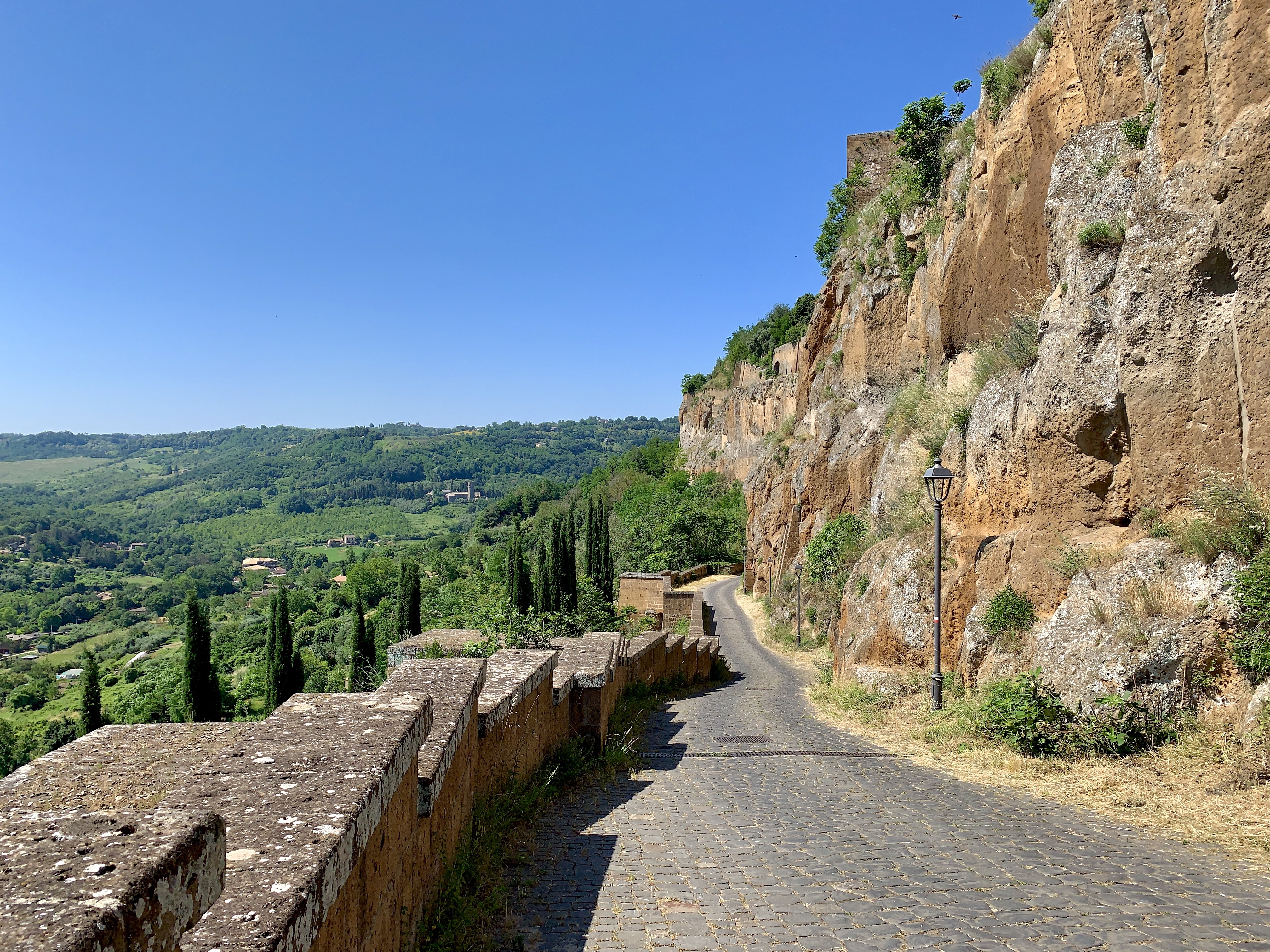 The trail below the rock, with a castle in the distance