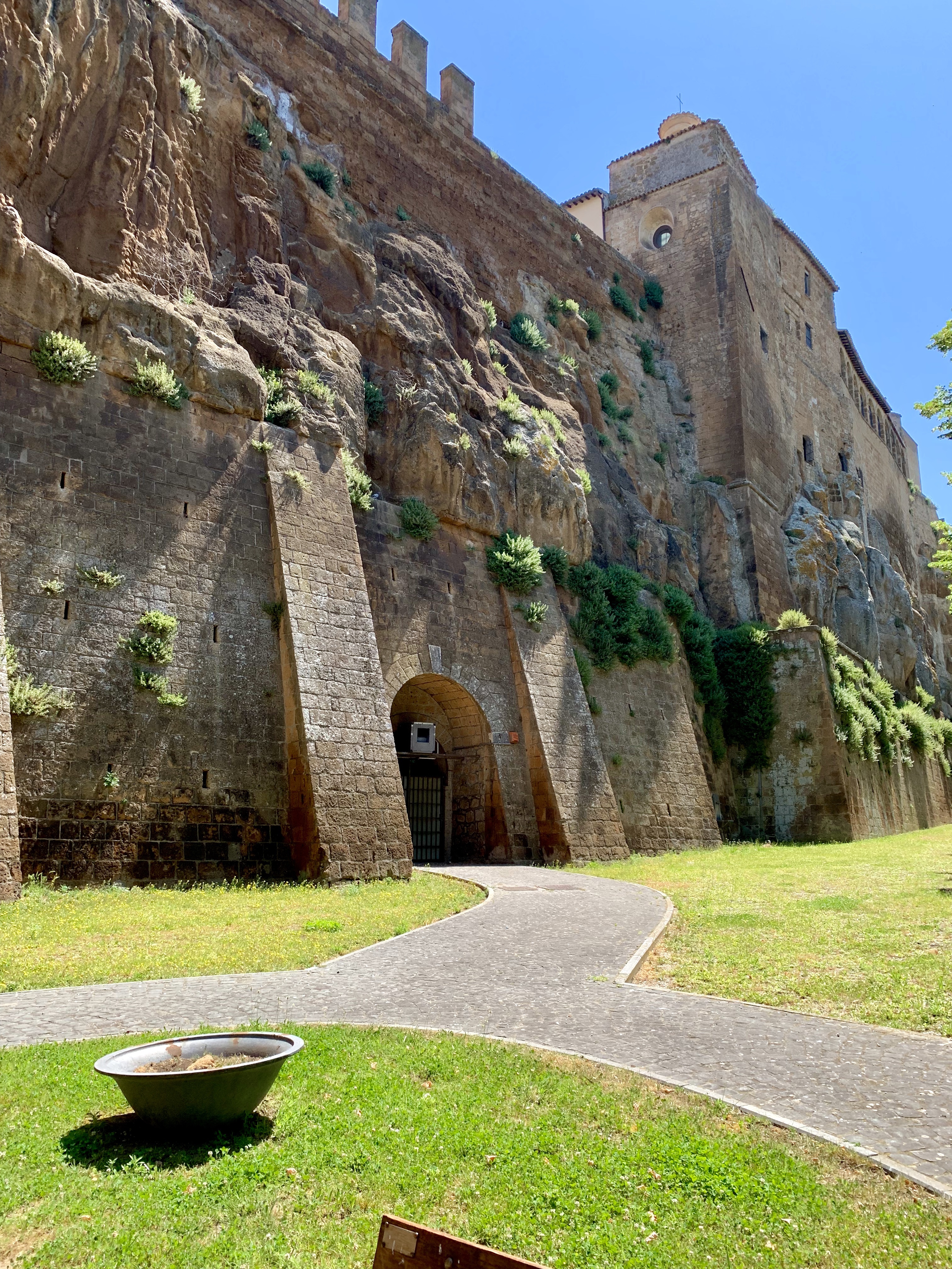 Lawn, path, rock, and battlements
