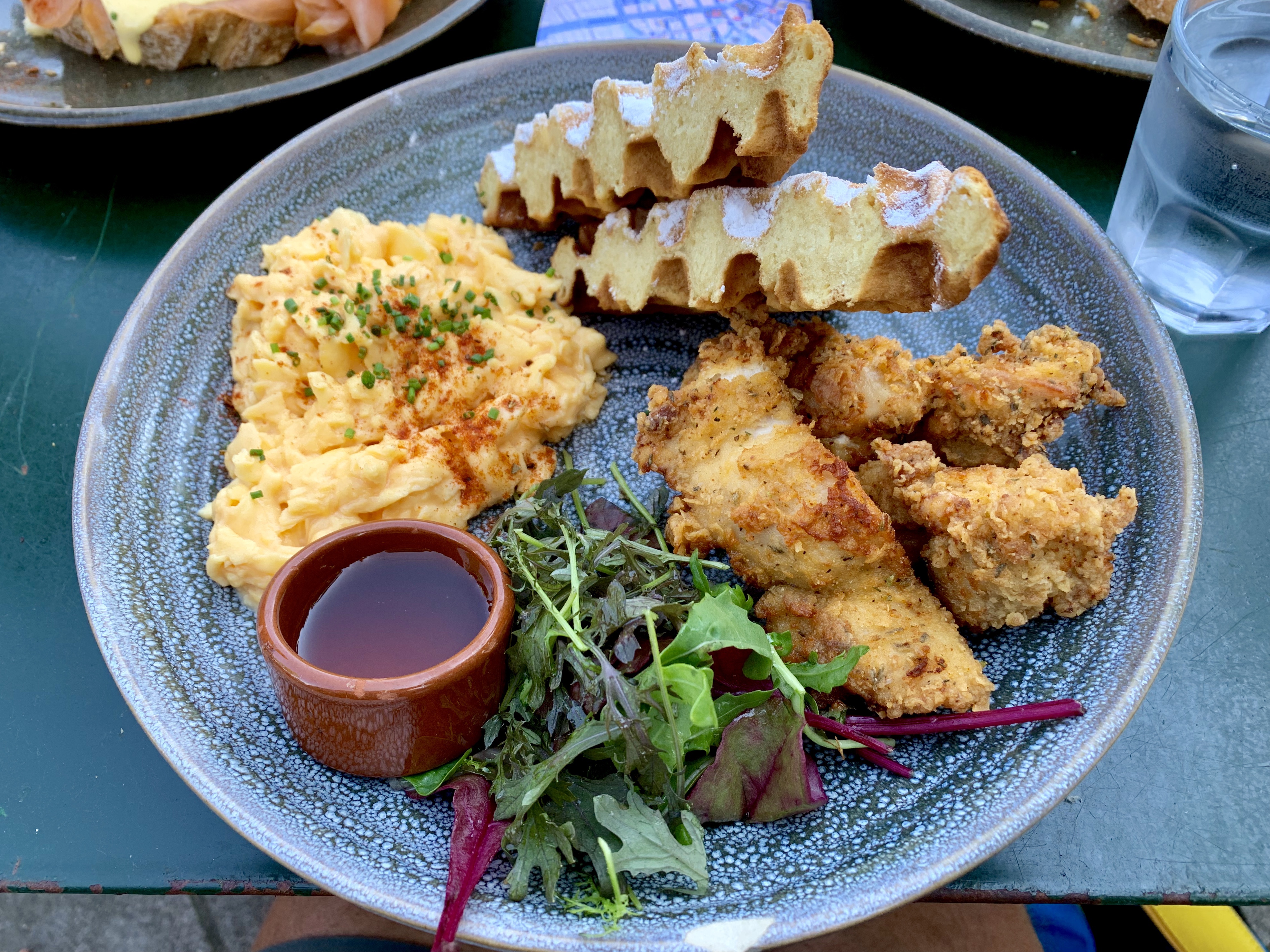 Fried chicken, scrambled eggs and waffles for breakfast